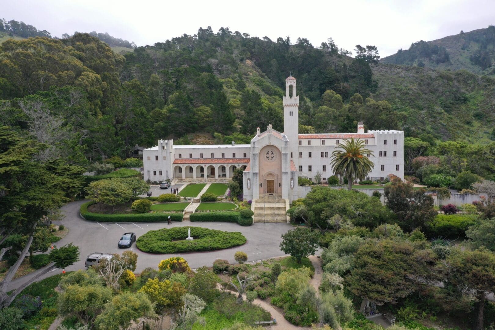 A large white building with trees in the background