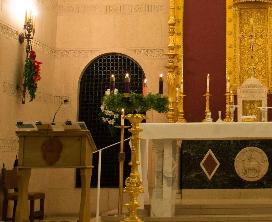 A church with candles lit in the center of it.